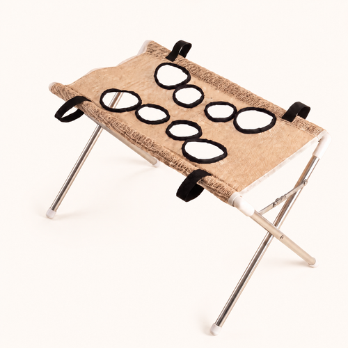 PupCradle dog bathing hammock in Beige on the warm cream website background